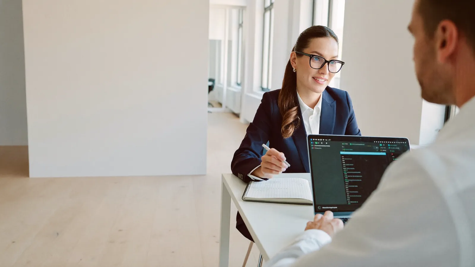 A studio meeting: a DreamSoft AI lead and a client in conversation